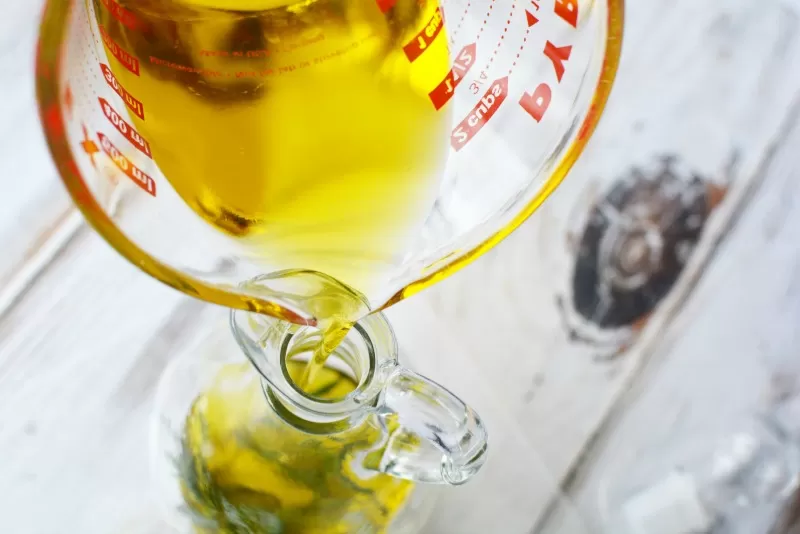 Pouring Olive Oil to make Rosemary Infused Olive Oil