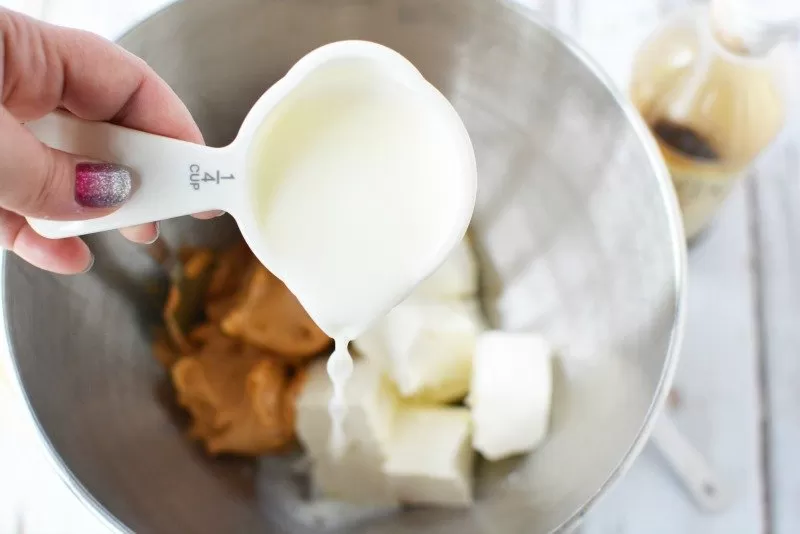 Adding ingredients for creamy peanut butter dip