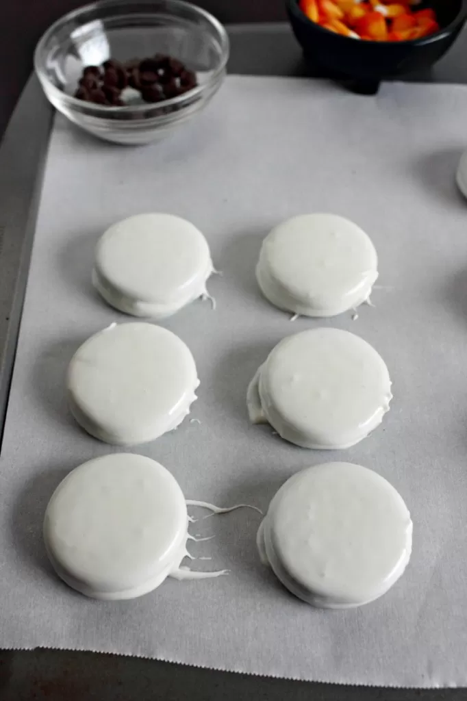 Dipping oreo cookies in melted candies