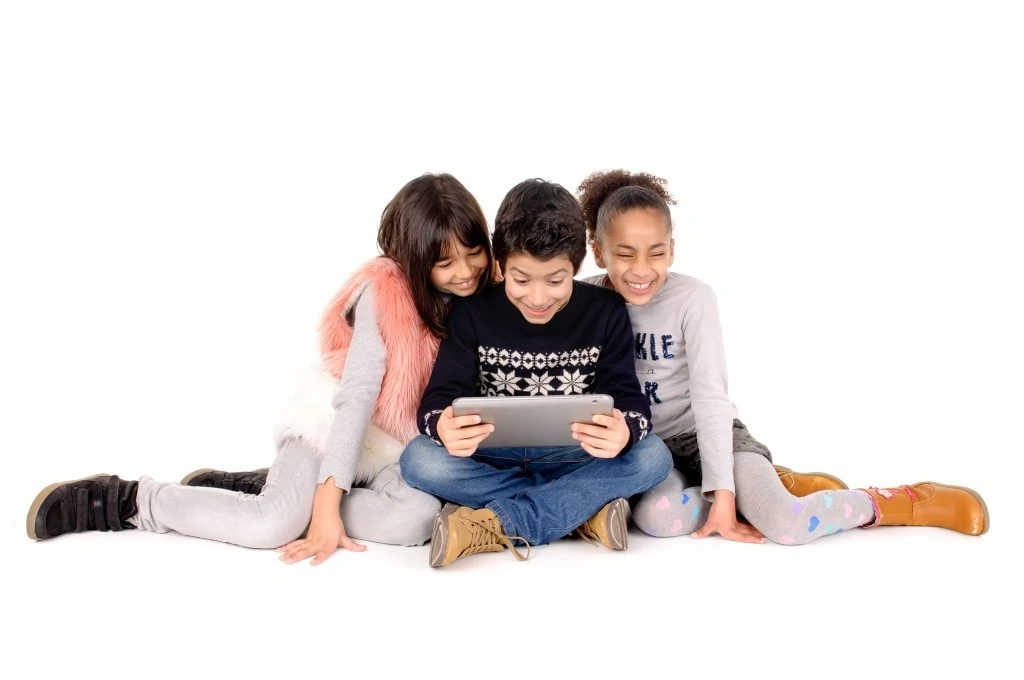 friends playing with tablet isolated in white background