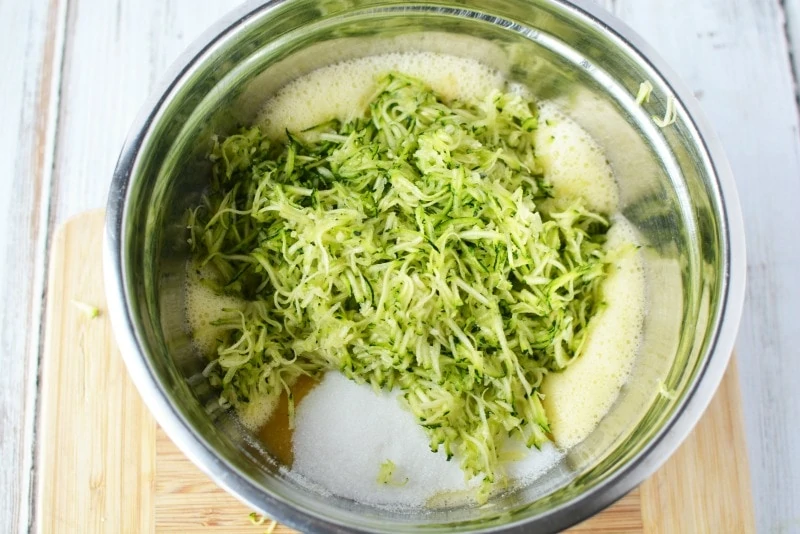 Adding ingredients for zucchini bread