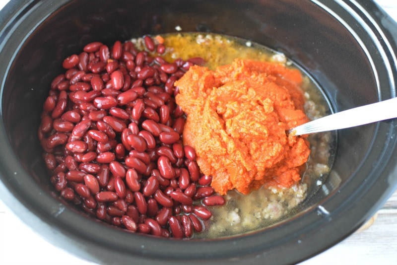 Adding ingredients to crockpot for Sausage Pumpkin Chili