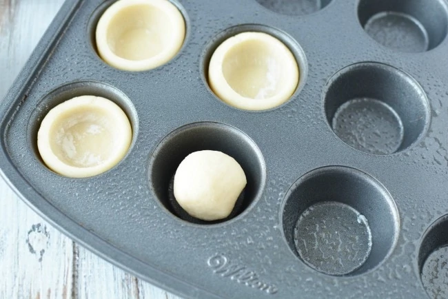 Dough for Easter basket cookies in muffin tin