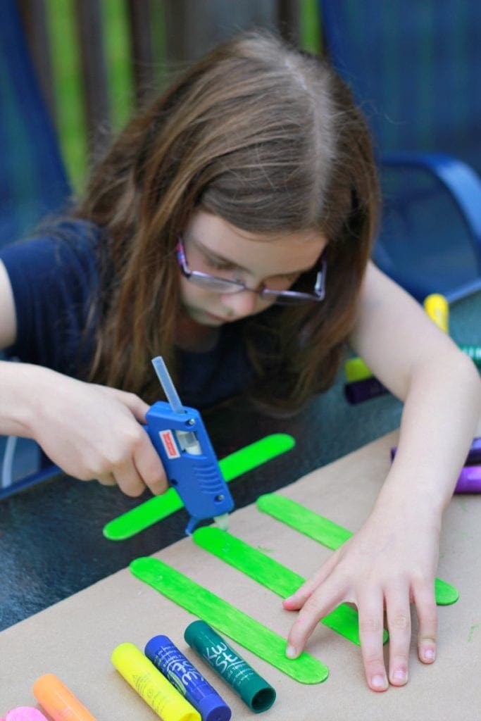 Putting popsicle sticks together for Father Day Frame