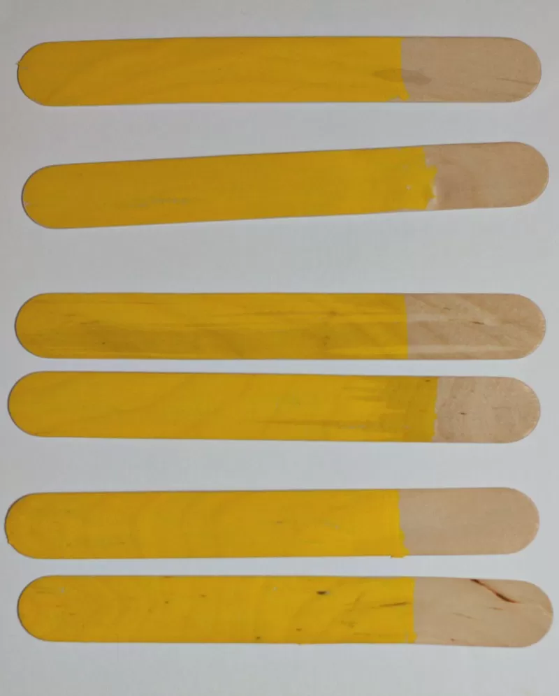 Popsicle sticks painted yellow
