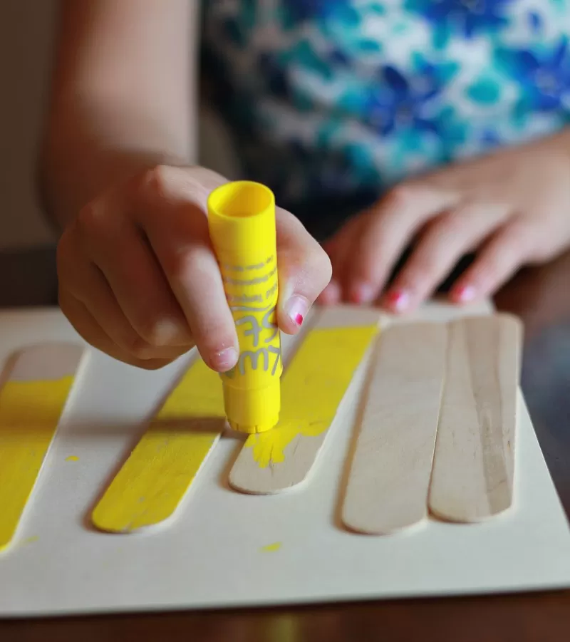 Using Kwik Stix to paint popsicle sticks for back to school frame