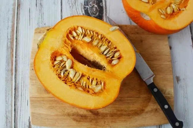 Cutting open the pumpkin with seeds