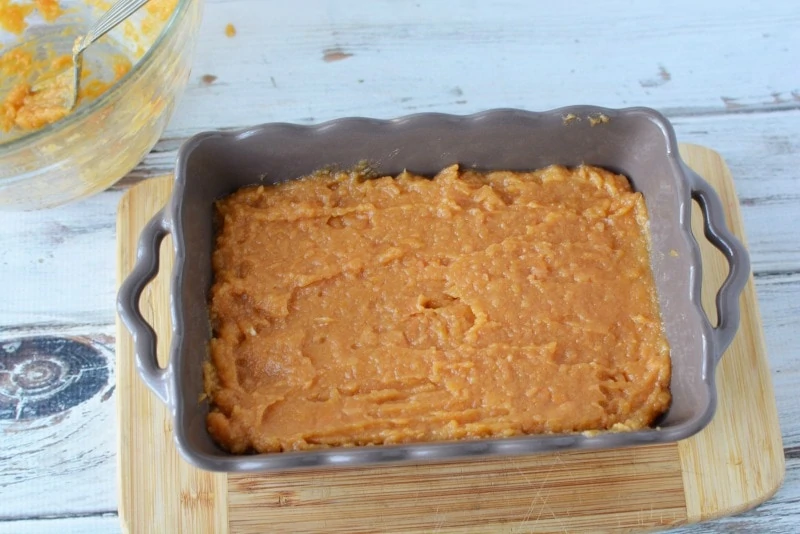 Putting sweet potato mixture into baking dish