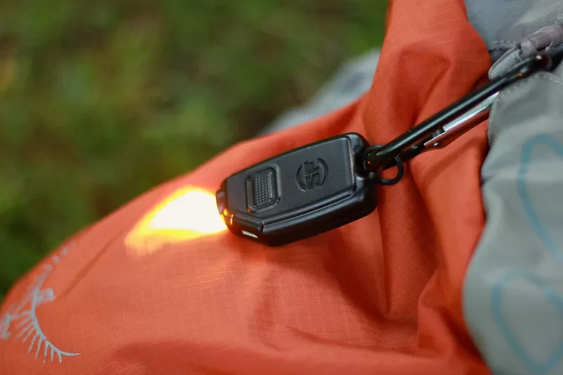 Surefire Sidekick Keychain Light attached to a carabiner for easy backpack access