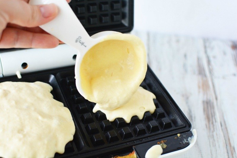 Pouring batter to make buttermilk waffles