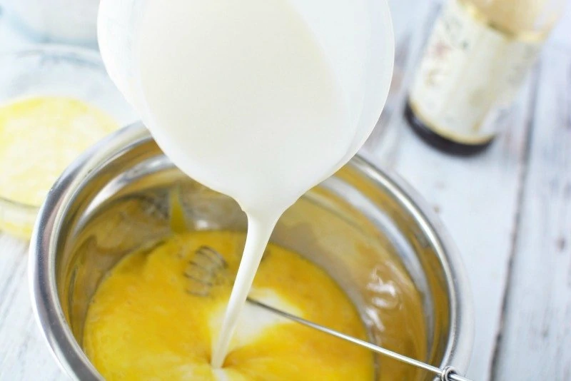 Pouring milk into buttermilk waffle ingredients