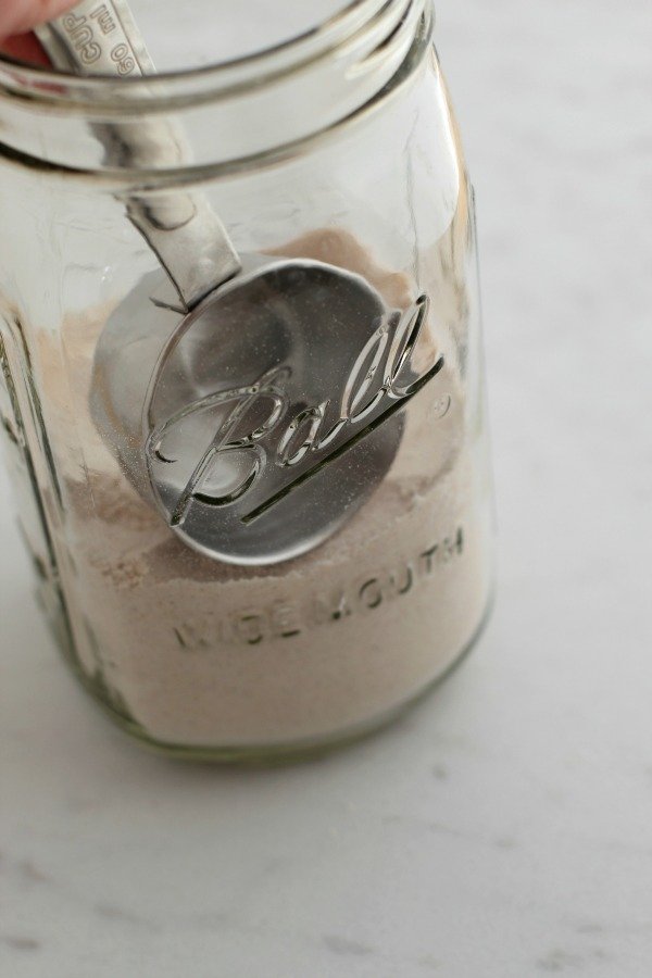 Adding gingerbread cookie ingredients to jar