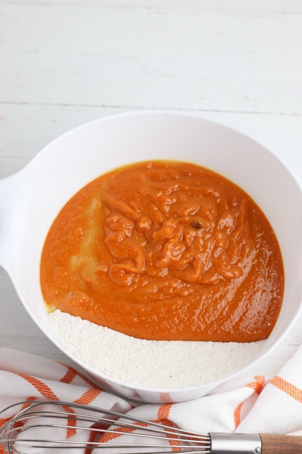 adding wet ingredients to dry ingredients for pumpkin donuts