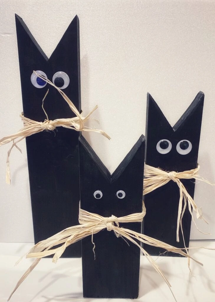 Black cats made from 2 x 4 wood pieces 