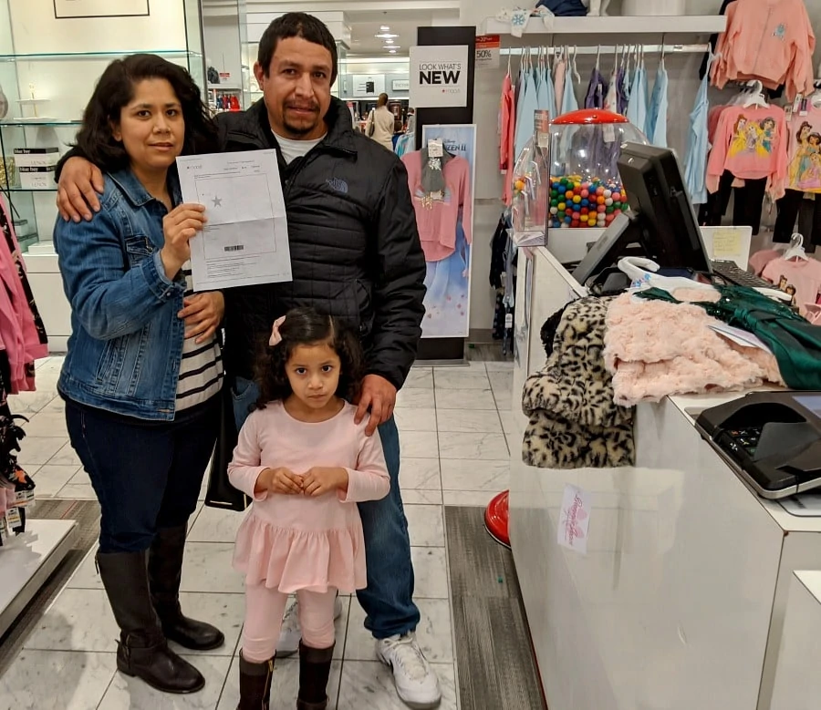 Family receiving Macys Surprise Gift Card