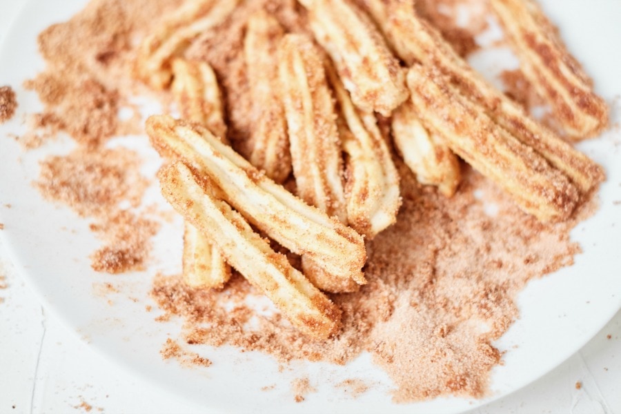Coat churros with cinnamon & sugar