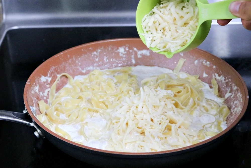 Chicken Alfredo Pasta adding cheese