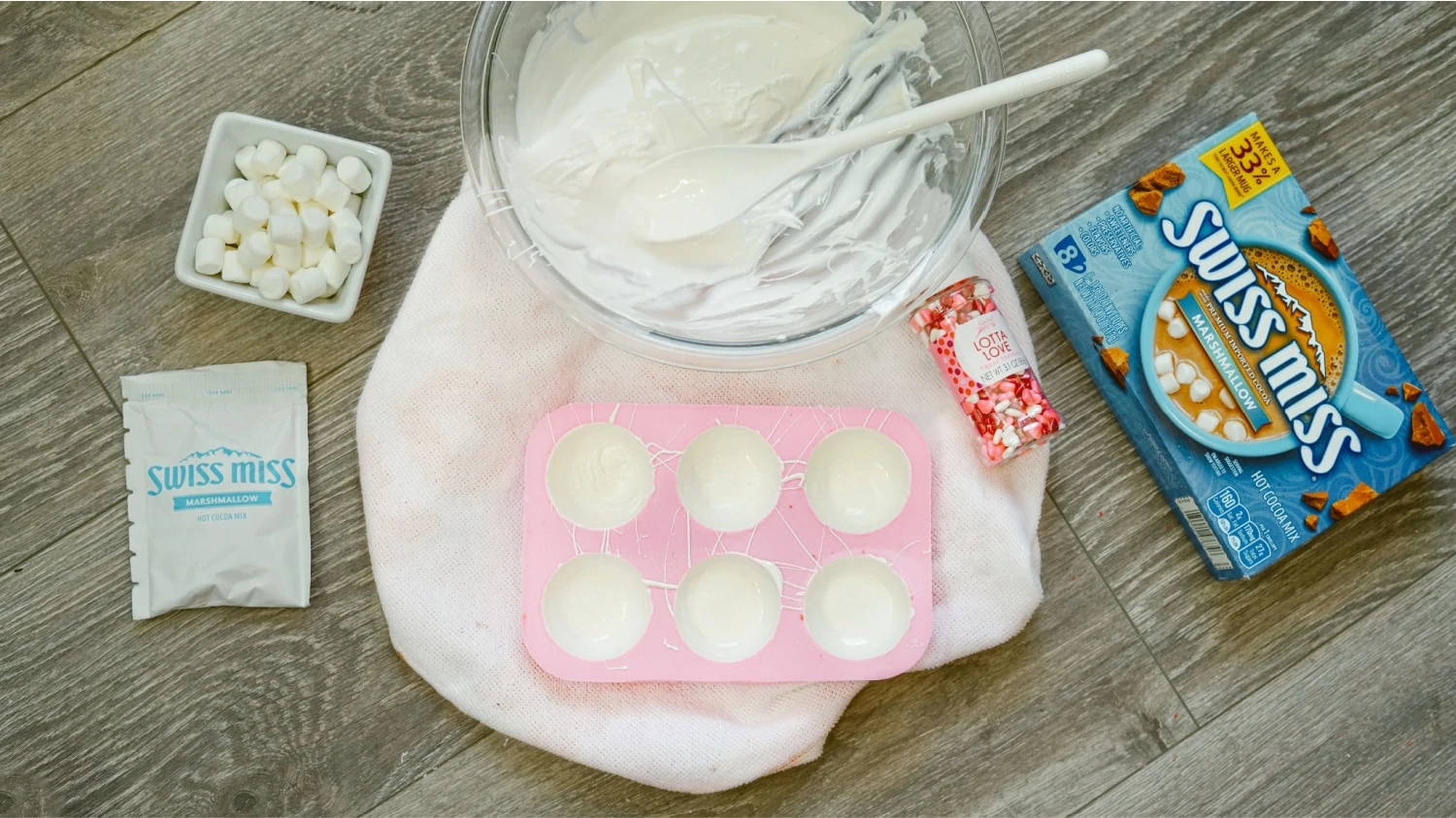 Filling the molds for hot chocolate bombs