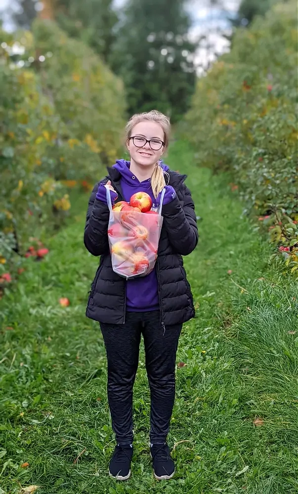 Apple Picking with bag full of apples at Bellewood farm