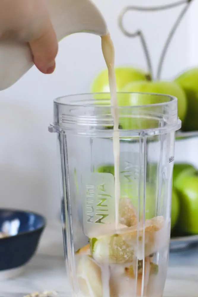 Pouring milk into smoothie ingredients