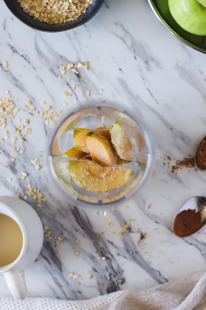 Putting apples into blender for apple pie smoothie