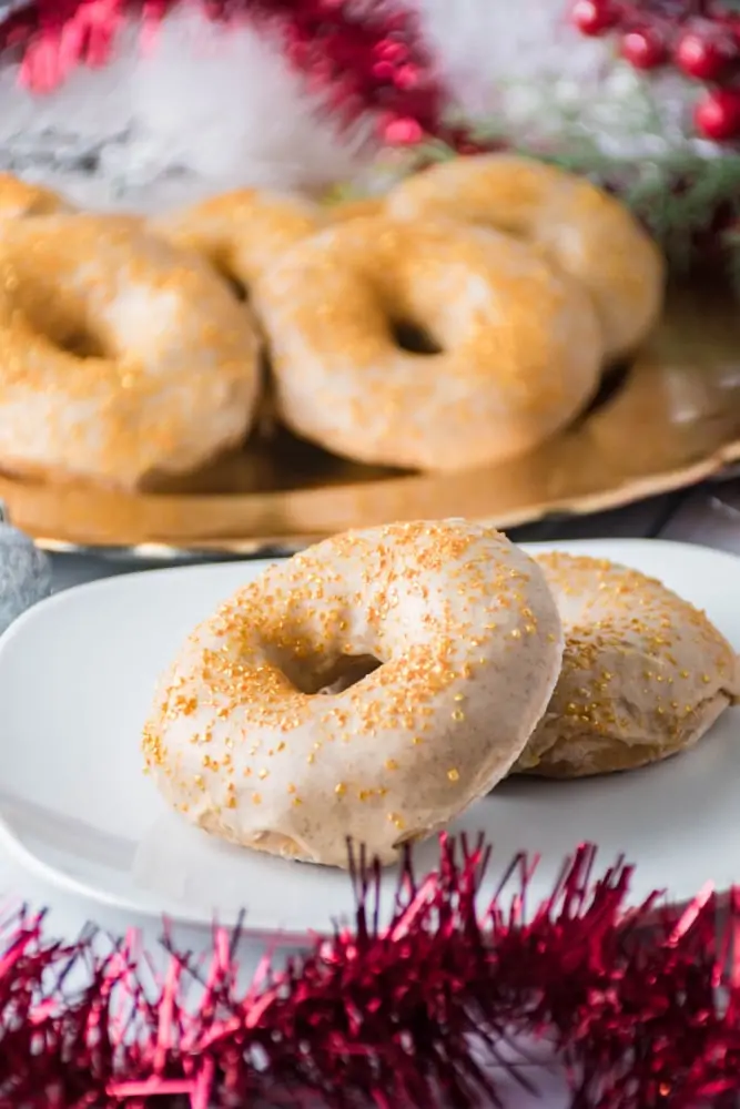 Eggnog Donuts on a plate with donuts in background