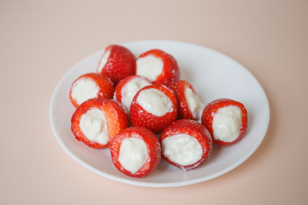 Adding cream cheese mixture to strawberries