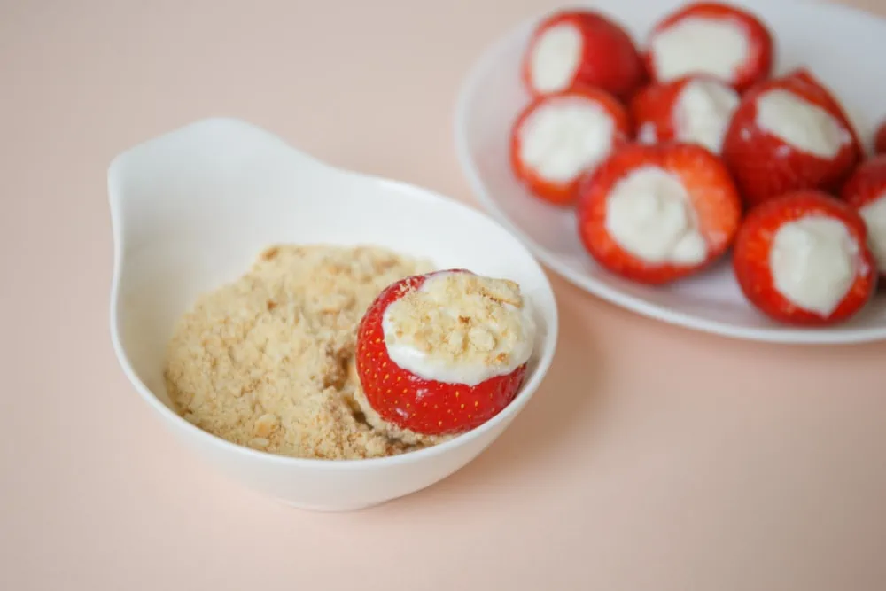 Adding graham cracker crumbs to strawberry cheesecake bites