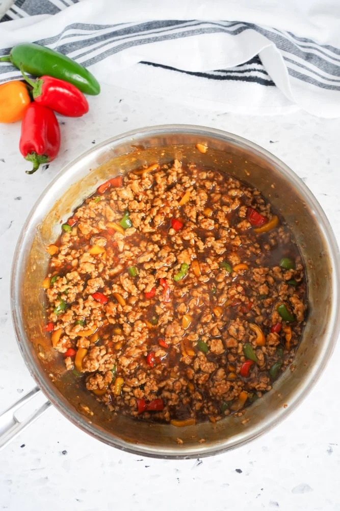 Adding teriyaki sauce to lettuce wraps