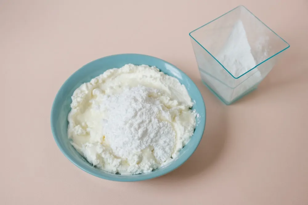 Mixing sugar & cream cheese for strawberry cheesecake bites