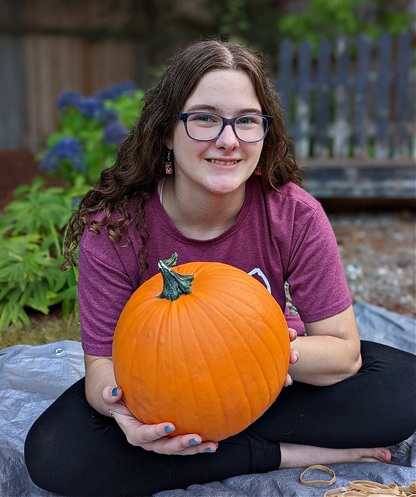 Holding round pumpkin