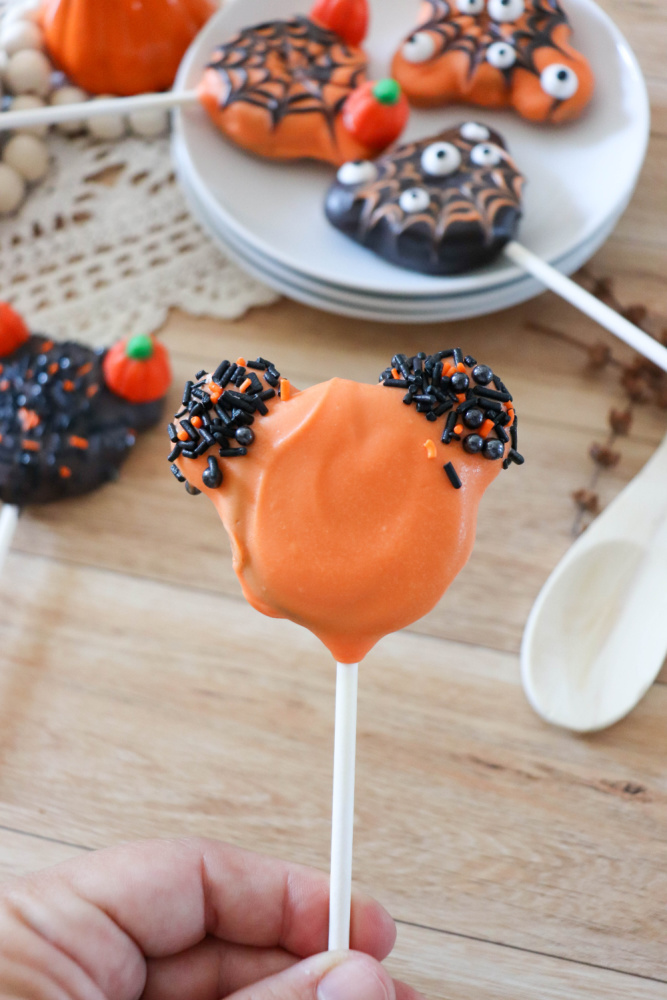 Adding sprinkles to Oreo Halloween Pops