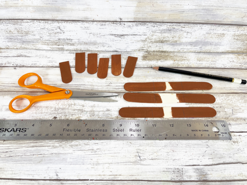 Measuring popsicle sticks for DIY acorn