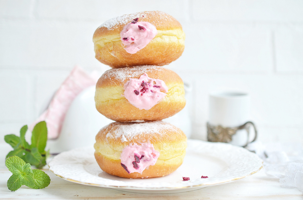 Raspberry Filled Donuts Stacked on a plate